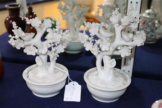 A pair of Chinese blanc de Chine models of birds in prunus trees